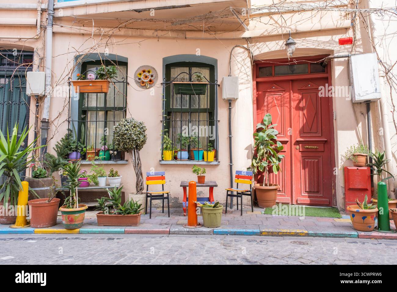 Farbenfrohe, beliebte Straßenecke in Balat, Istanbul. Blick auf die lebhafte, schöne Hausfront, Topfpflanzen, rote Türen und yildirim Street Charme Stockfoto