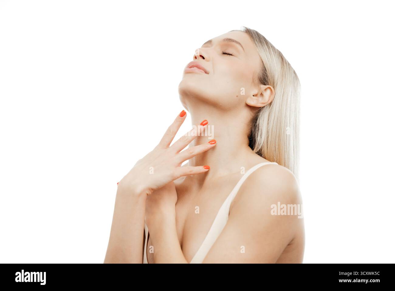 Eine Frau mit klarer Haut berührt sanft ihren Hals und hebt ihre Schönheit und Kosmetik hervor, beleuchtet von sanftem Licht und schafft einen ruhigen und strahlenden geldautomaten Stockfoto