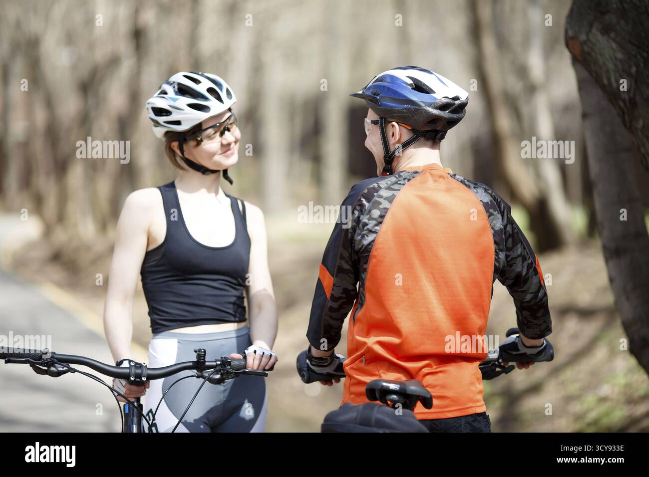Zwei Radfahrer in Helmen am Nachmittag im Park Stockfoto