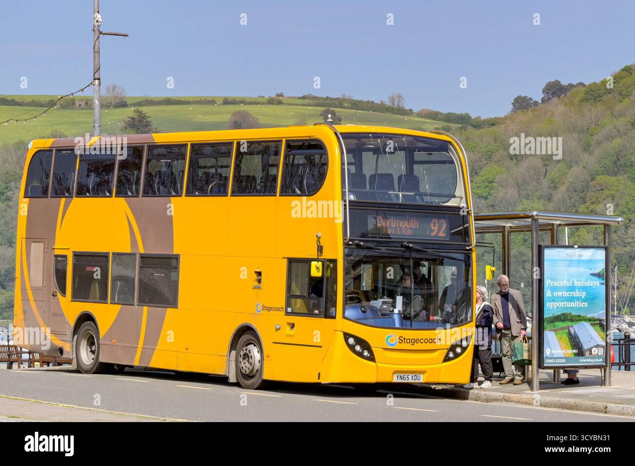 Dartmouth, Devon, England, Großbritannien - 24. April 2025: Personen, die an einer Bushaltestelle in Dartmouth in einen von Stagecoach betriebenen Doppeldeckerbus steigen. Stockfoto