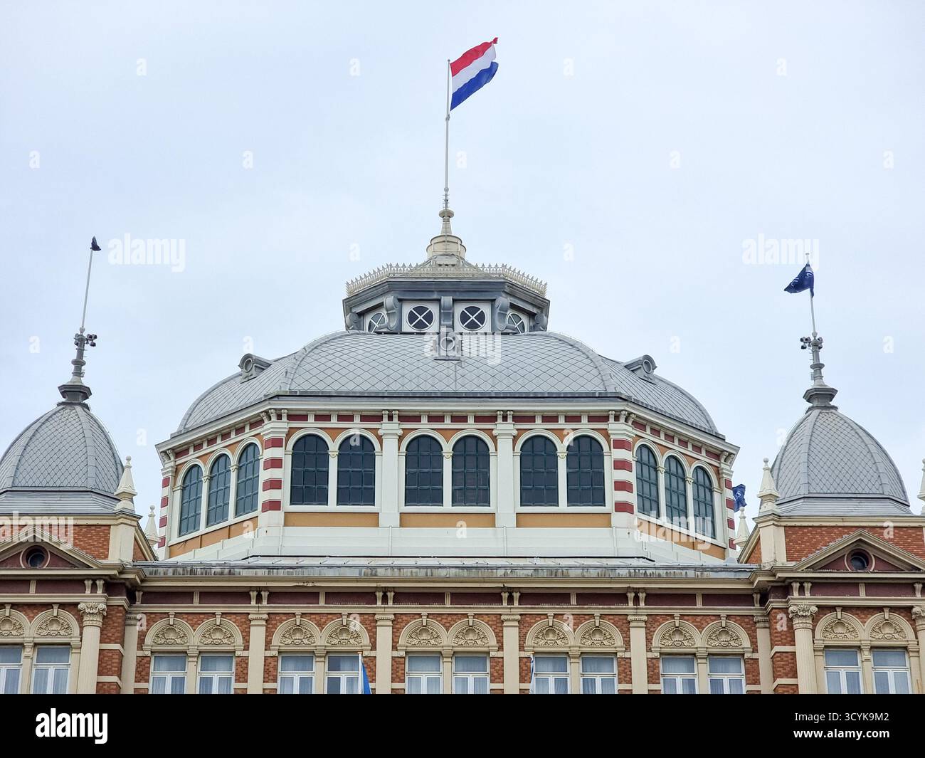 Kuppel des Grand Hotel Amrâth Kurhaus Scheveningen in den Haag Niederlande mit niederländischer Flagge; monumentales Gebäude - Smartphone-aufgenommenes Stockfoto