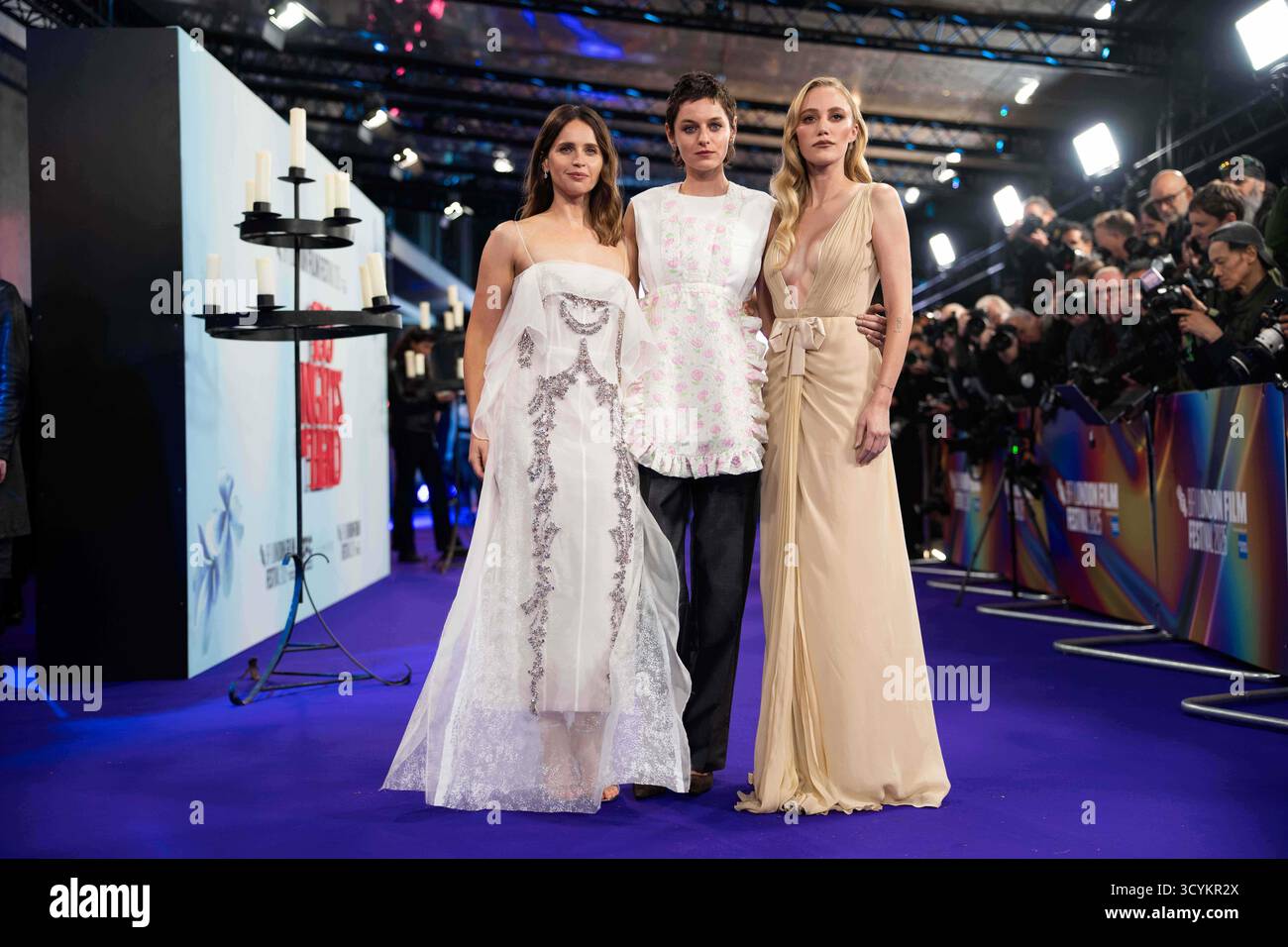 Felicity Jones, from left, Emma Corrin and Maika Monroe pose for photographers upon arrival at the premiere of the film "100 Nights of Hero" which closes the London film festival in London, Sunday, Oct. 19, 2025. (Photo by Scott A Garfitt/Invision/AP) Stockfoto