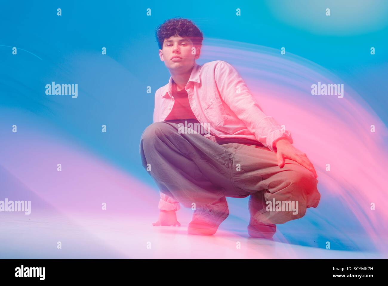 Urban Breaker hockt sich in Neonlichtschichten, dynamischer Hip-Hop-Vibe für Musik-Promos, Werbung für Jugendkultur, Poster und Event-Branding. Stockfoto