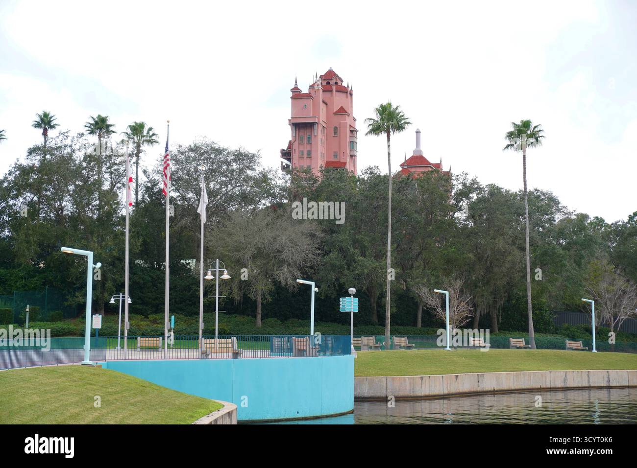 Die Attraktion Hollywood Tower Hotel erhebt sich über Bäumen und Palmen gesäumten Fußgängerwegen nahe dem Eingang der Disney's Hollywood Studios in Orlando Stockfoto