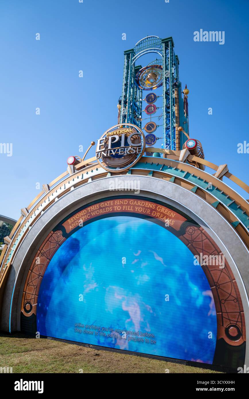 Eingangsportal zum Freizeitpark Epic Universe von Universal unter einem klaren blauen Himmel mit den bunten sich drehenden Planeten und dem digitalen Bogengang Stockfoto