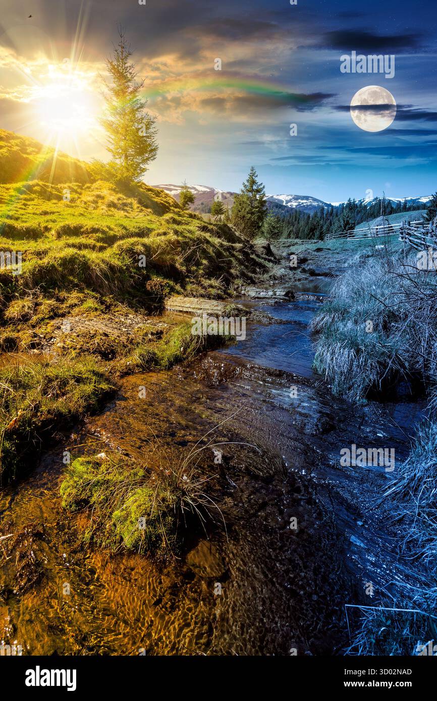 Ländliche Szene der Berglandschaft am Frühlingsnachtgleiche. Tag- und Nachtzeitwechsel. Grüne Landschaft mit bewaldeten Hügeln mit Sonne und Mond bei twi Stockfoto