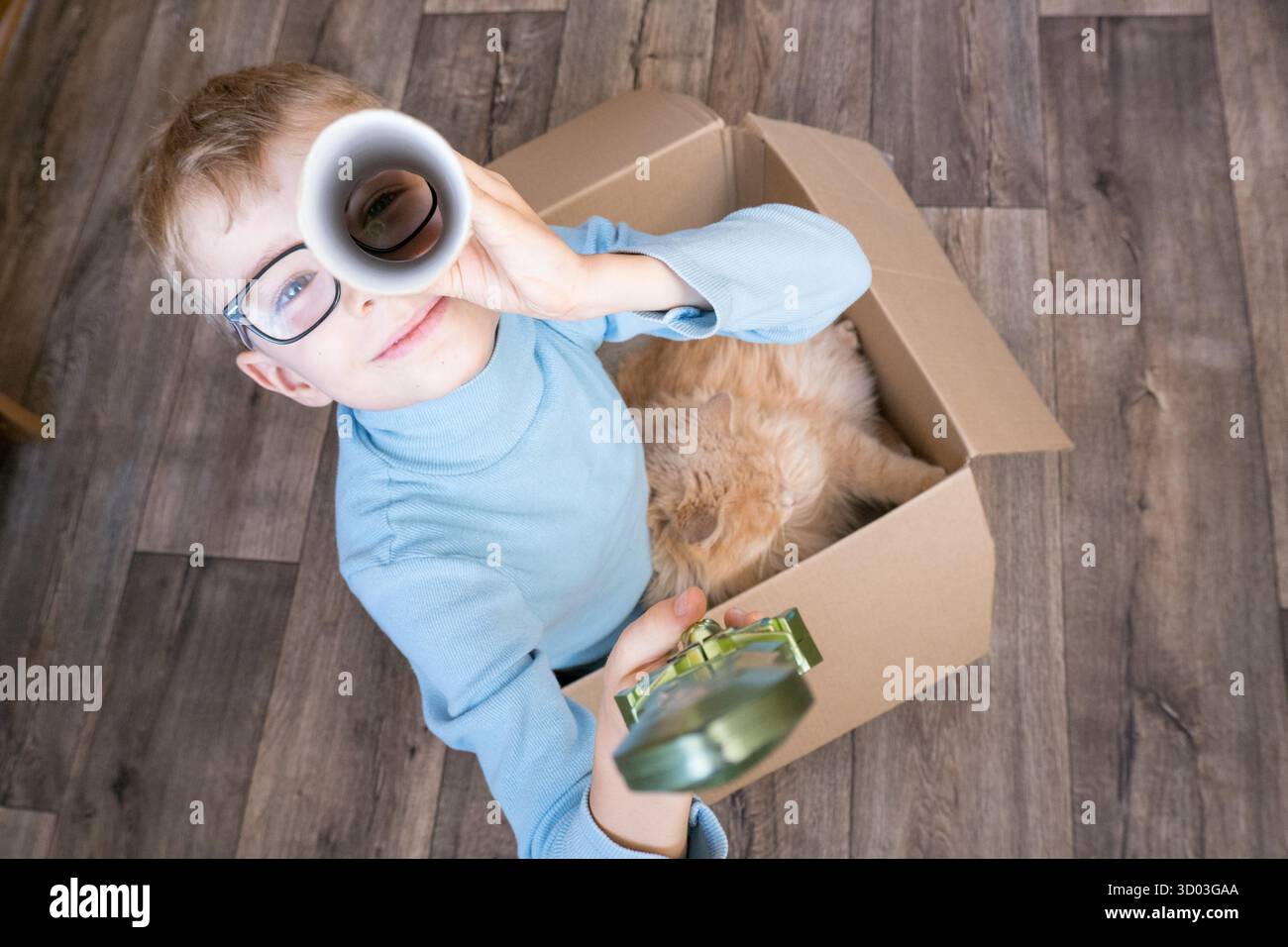 Ein kleines Kind, ein Junge, spielt einen Piraten mit einer Katze, die in einer Kiste sitzt. Kinderspiele im Kinderzimmer. Echte Freundschaft || Model veröffentlicht Stockfoto Ein kleines Kind, ein Junge, spielt einen Piraten mit einer Katze, die in einer Kiste sitzt. Kinderspiele im Kinderzimmer. Echte Freundschaft || Model veröffentlicht Stockfoto