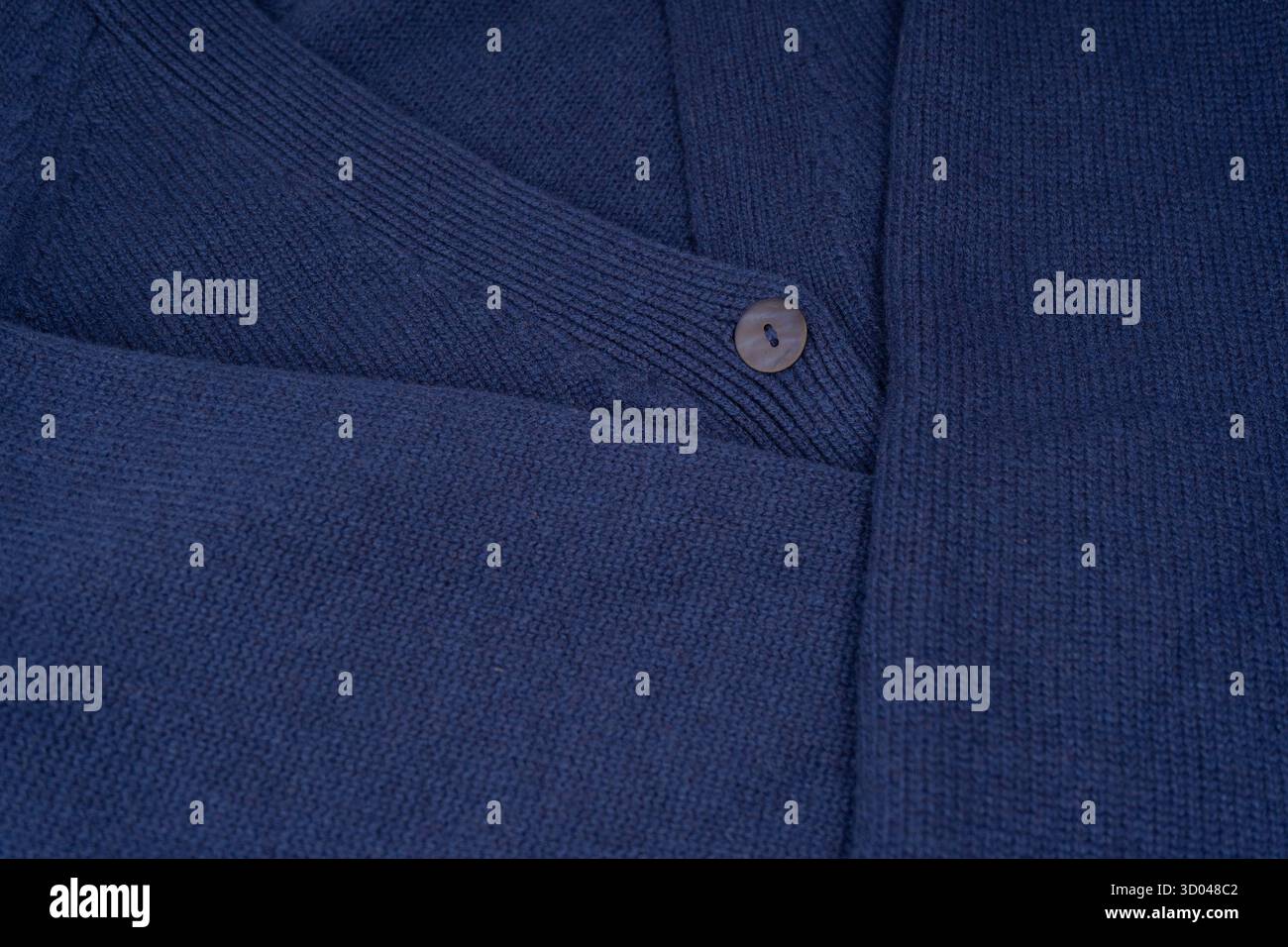 Marineblaue Strickjacke aus Merinowolle als Hintergrund. Draufsicht. Stockfoto