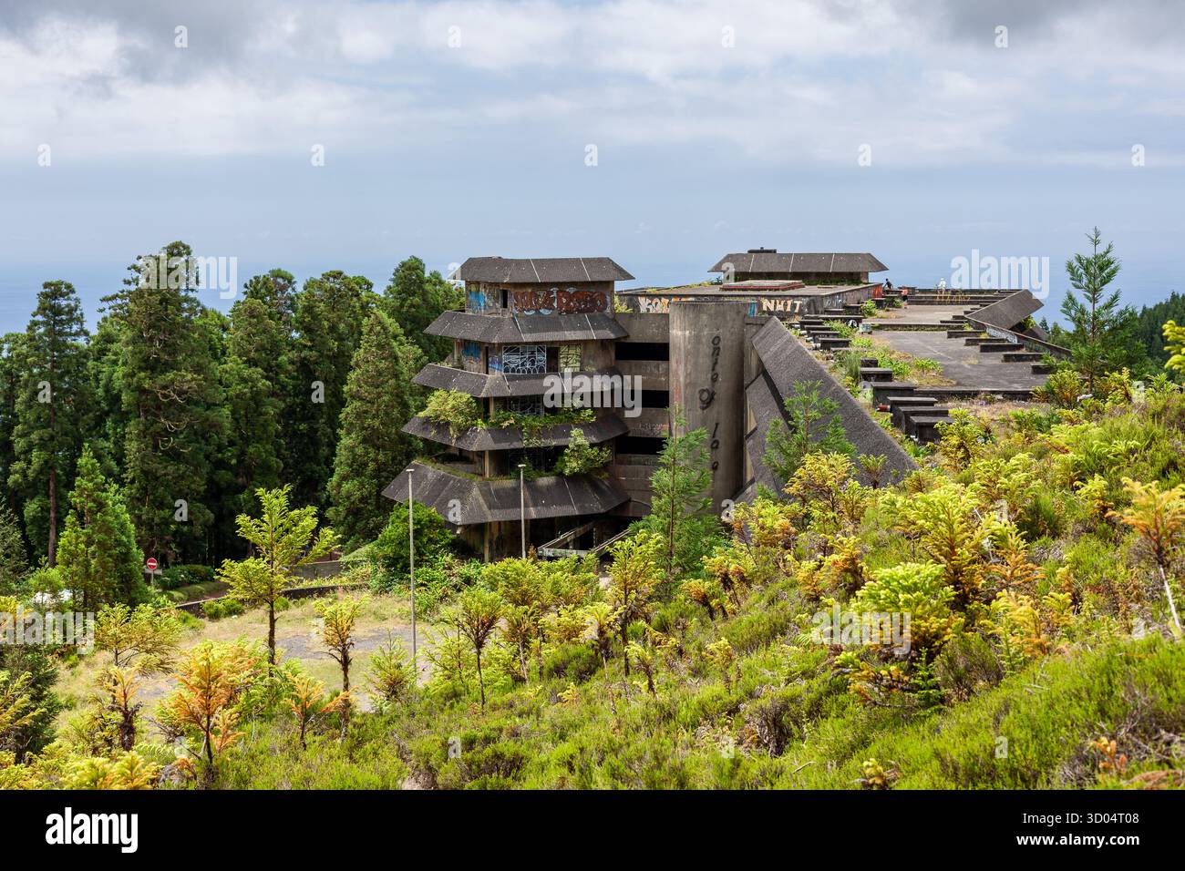 Verlassenes Monte Palace Hotel in Sao Miguel, Azoren, umgeben von üppiger Natur und bewölktem Himmel. Stockfoto
