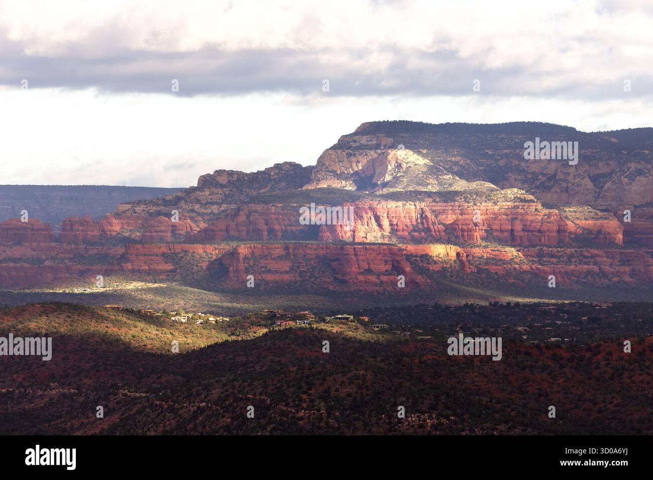 Ein bewölkter Sonnenaufgang erzeugt Schatten und einen 3D-Effekt über den roten Felsenbergen von Sedona an einem wunderschönen späten Sommermorgen in Arizona. Stockfoto