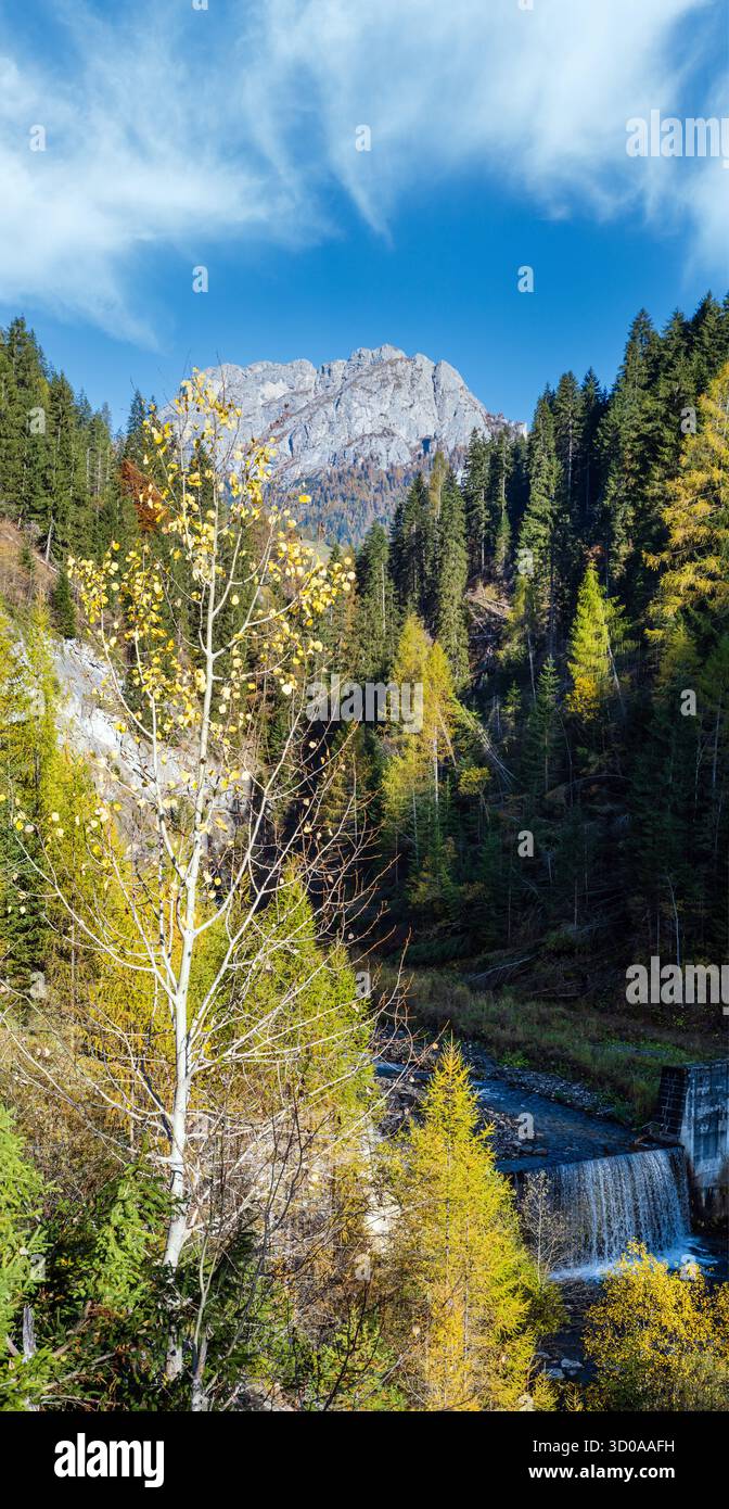 Autumn alpine Dolomites mountain view with small cascade waterfall, Colle Santa Lucia region, Sudtirol, Italy. Picturesque traveling, seasonal, and na Stockfoto