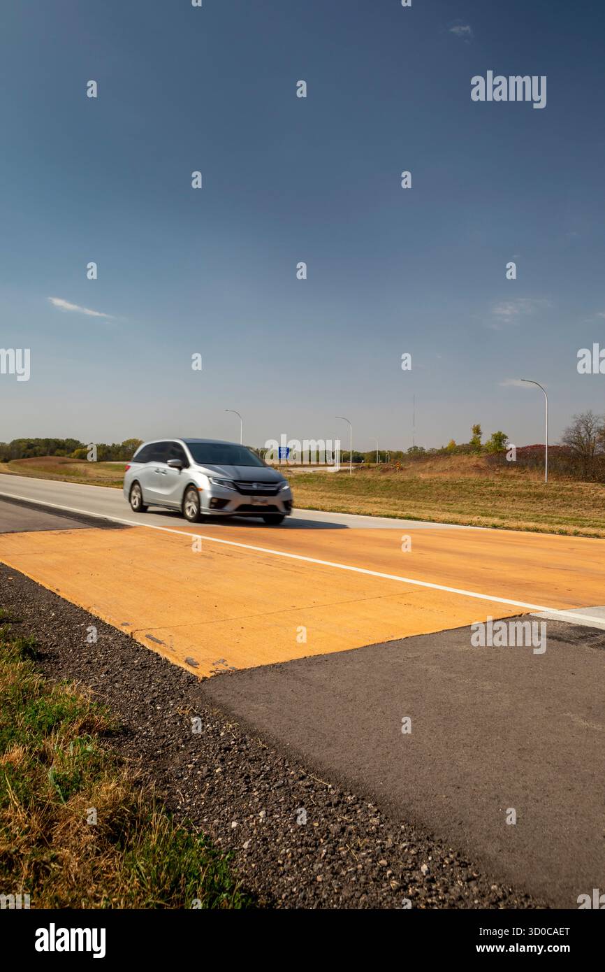 Blue Earth, Minnesota – Ein „Goldener Streifen“ aus gelbem Bürgersteig markiert die Stelle, an der die Interstate 90 1978 fertiggestellt wurde. 3.099 Meilen von Bos entfernt Stockfoto