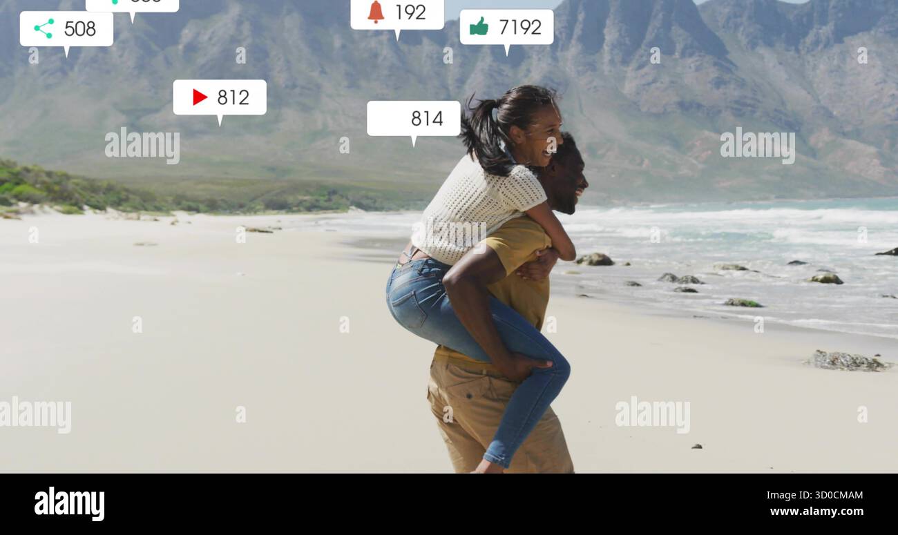 Mann mit Partner auf dem Rücken, der entlang des Strandes in der Nähe von Bergen läuft, mit schwimmenden Interaktionssymbolen Stockfoto