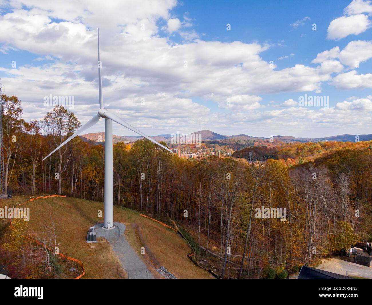 Die Windturbine der Appalachian State University bildet eine Silhouette gegen die Blue Ridge Mountains in Boone, North Carolina Stockfoto