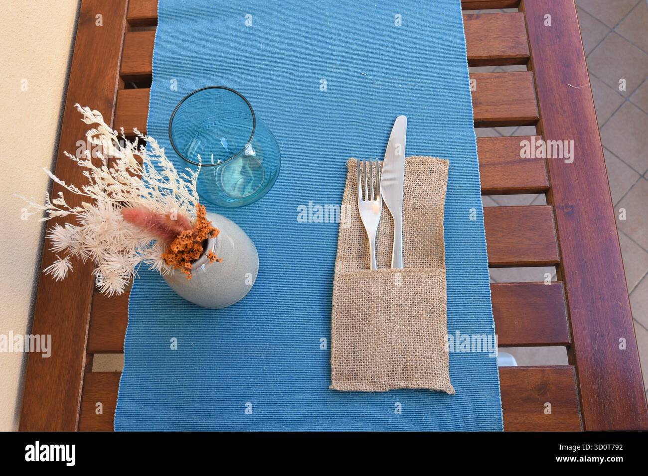 Mize en Place mit blauer Tischdecke und herbstlichen künstlichen Blumen Stockfoto