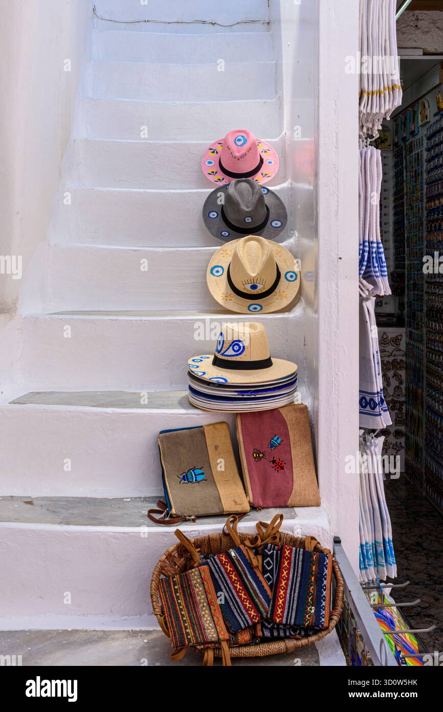 Ausstellung von Waren zum Verkauf auf Stufen vor einem Geschäft in der weiß getünchten Altstadt von Naxos, Kykladen, Griechenland Stockfoto