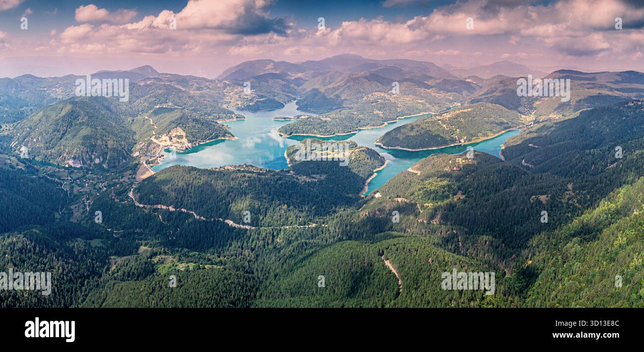 Aus der Vogelperspektive mit dem Stausee Zaovine, einem Damm und den umliegenden Bergen, die mit Wald bedeckt sind Stockfoto