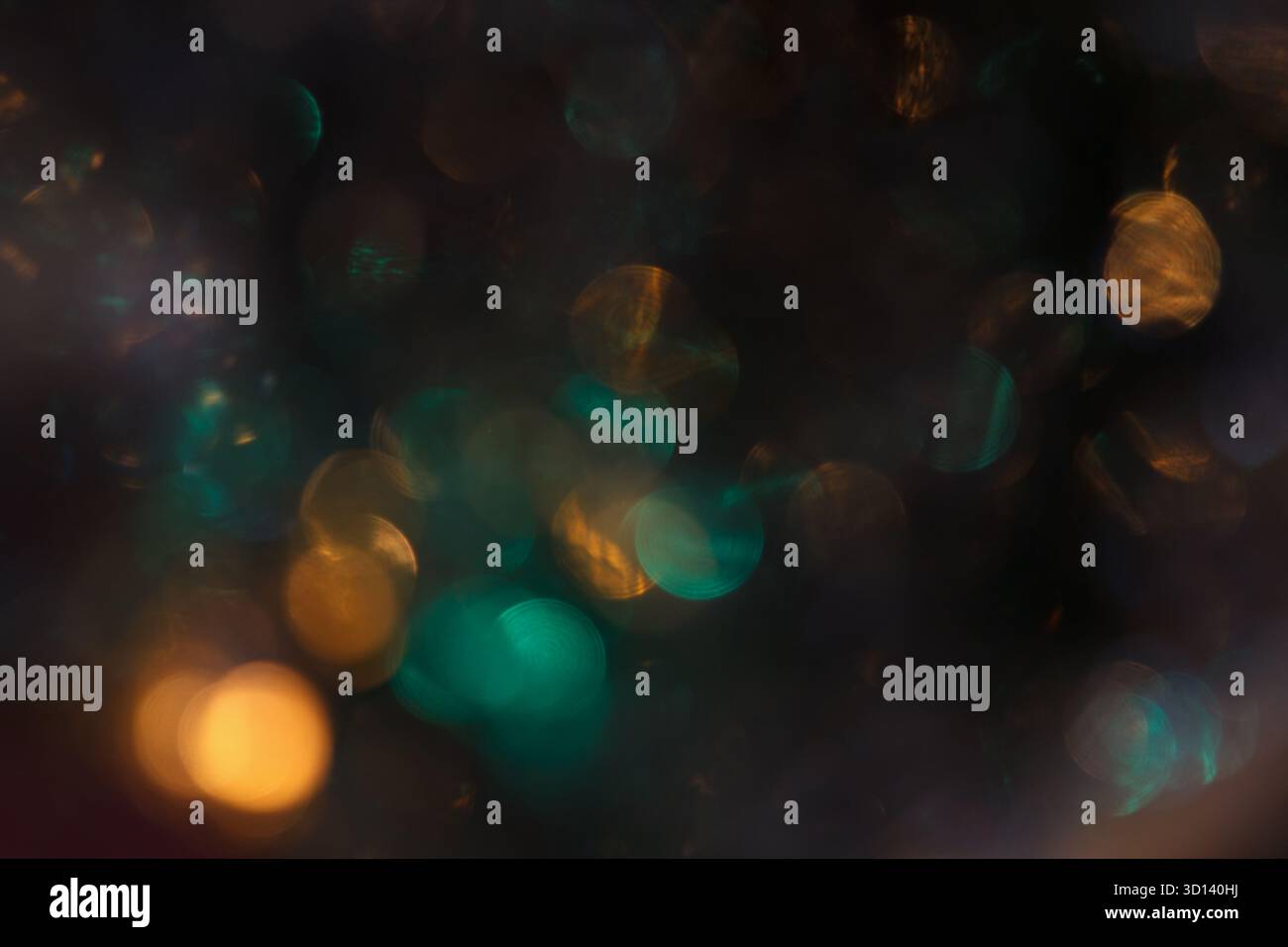 Abstrakter Bokeh-Hintergrund mit weichen, verschwommenen Lichtern in Gold- und Blautönen. Die Szene schafft eine traumhafte, festliche Atmosphäre Stockfoto