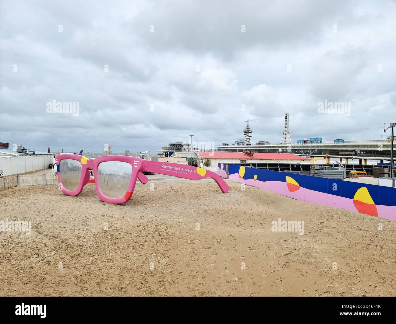 Riesige pinkfarbene Sonnenbrille: Kunstwerk „Scheveningen is Look out for you“ am Strand von Scheveningen, den Haag, Niederlande - Smartphone-aufgenommenes Stockfoto