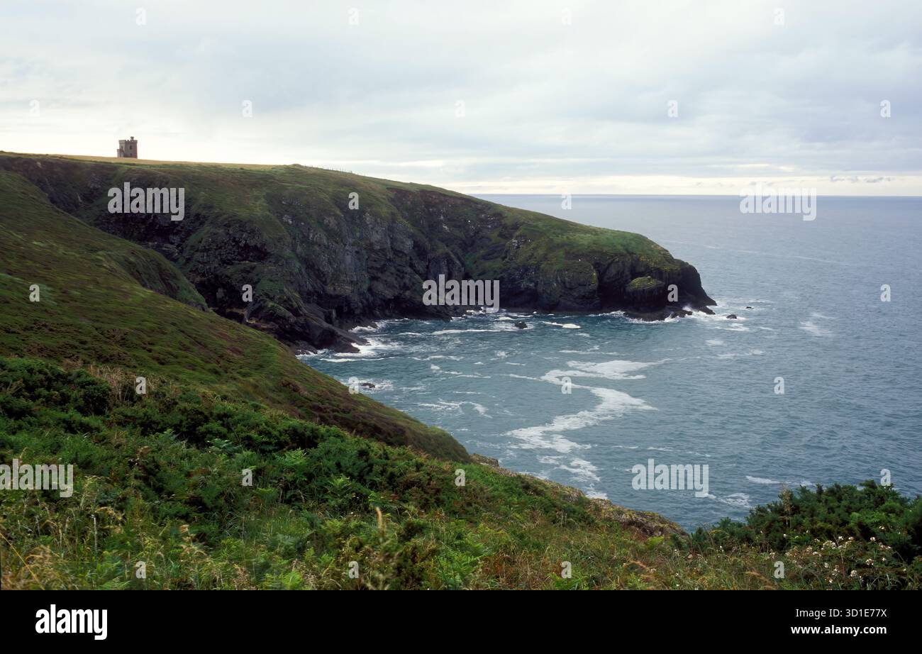 Klippen entlang der Küste der Südküste Irlands. Ardmore Watch Tower auf der Spitze der Klippe. Stockfoto