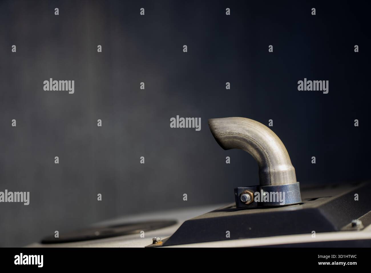 Auspuffrohr aus Edelstahl an der oberen Abdeckung des industriellen Generators mit präziser Metallverarbeitung, mechanischer Haltbarkeit und technischer Leistung Stockfoto