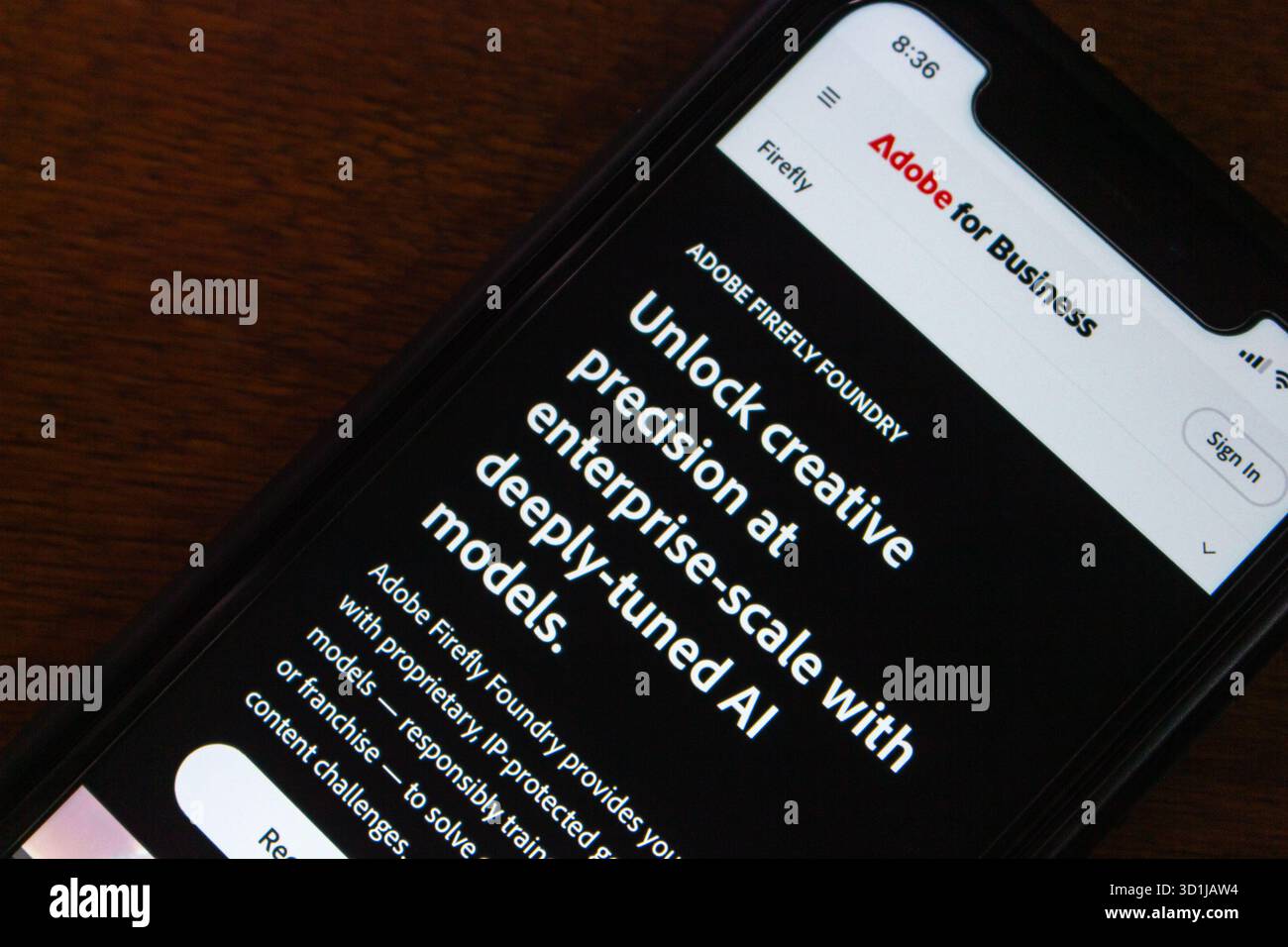 Smartphone-Bildschirm, auf dem die Website von Adobe for Business für Firefly Foundry promotet, die fortschrittliche generative KI-Modelle für kreative Unternehmenslösungen bietet. Stockfoto