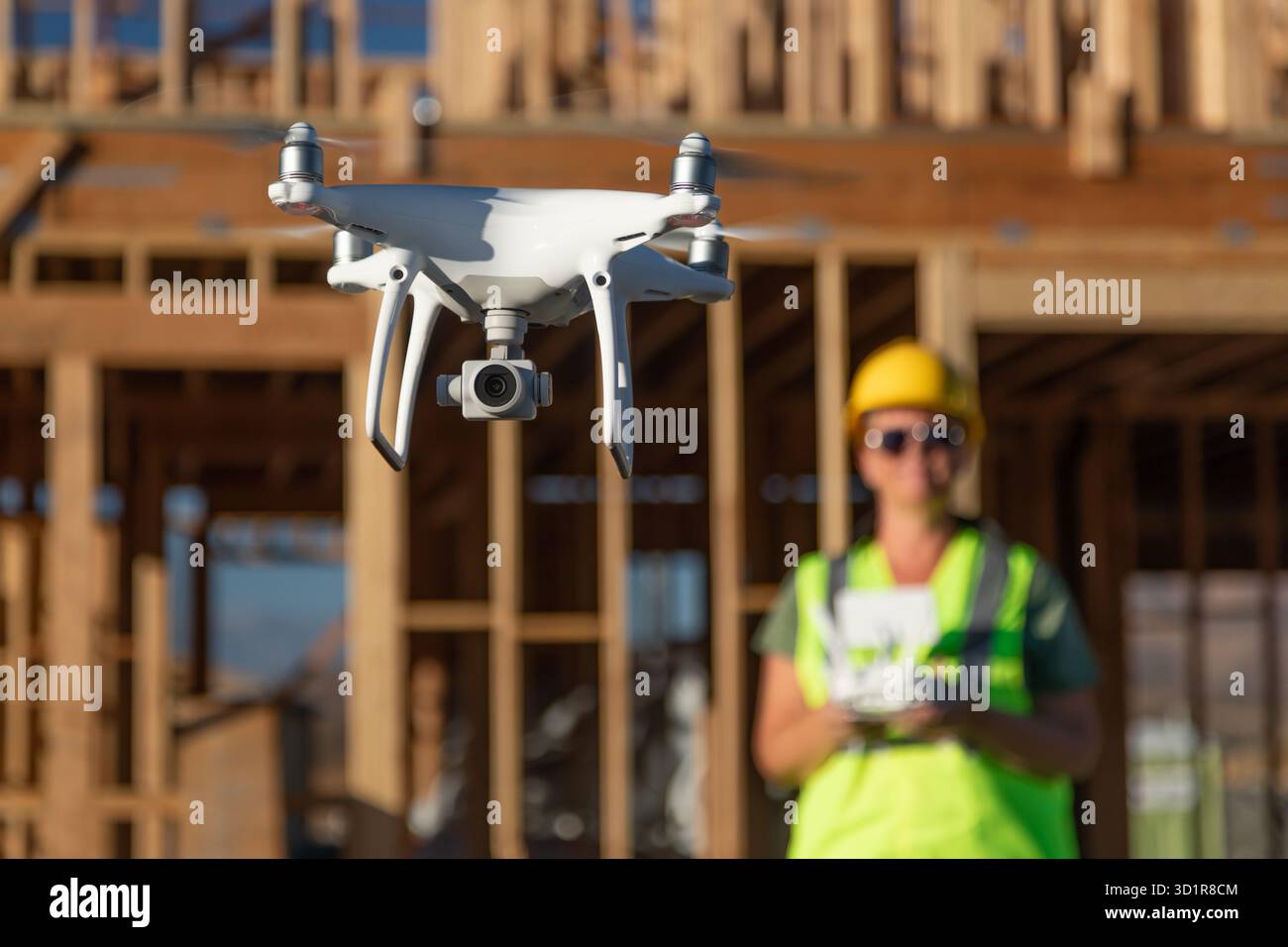 Weibliche Pilotin Fliegt Drohnen-Quadcopter Auf Baustelle Stockfoto
