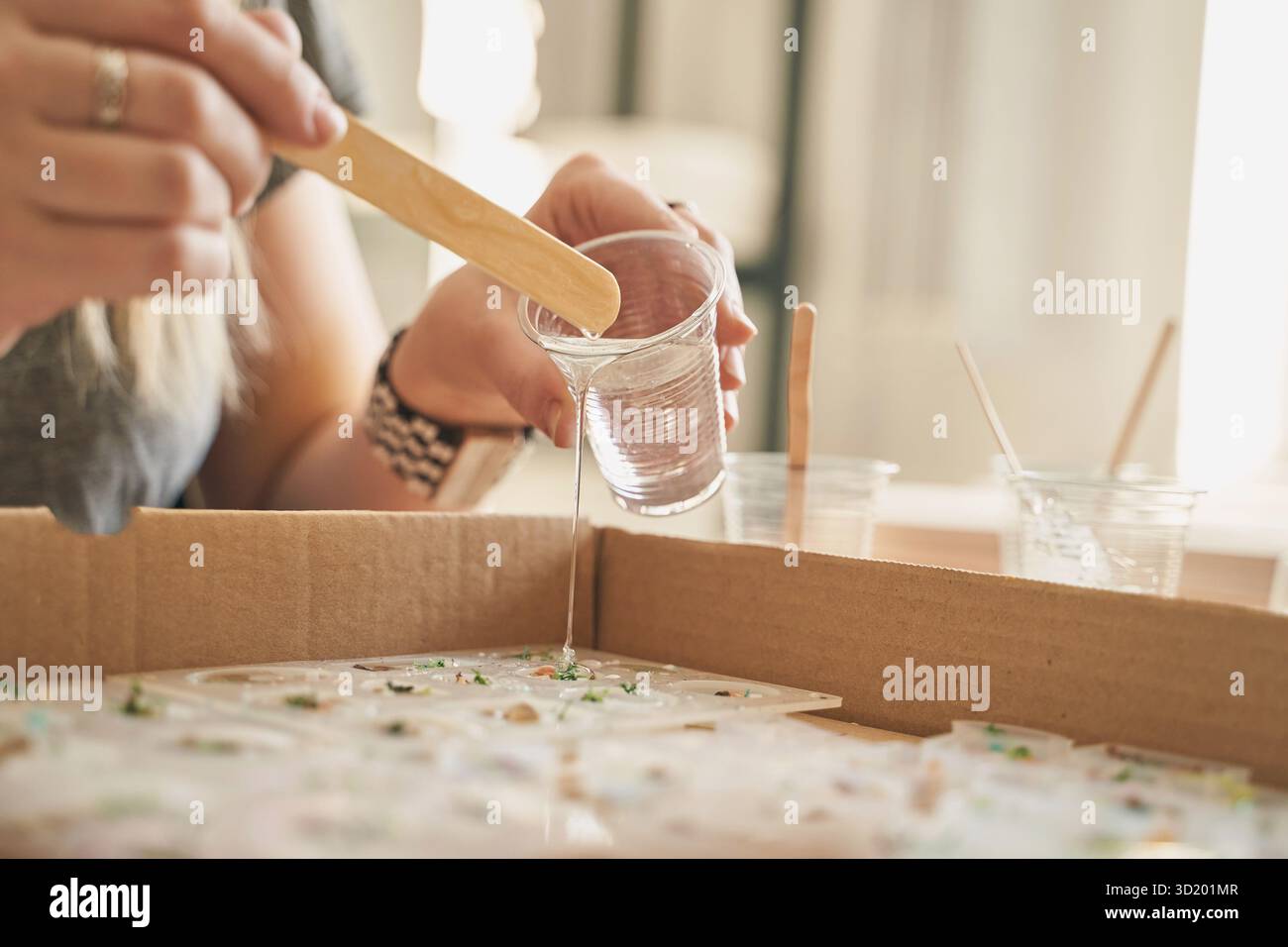 Kunsthandwerk: Kunsthandwerk für Frauen, kaukasier, Erwachsene mit Epoxidharz und Formen. Stockfoto