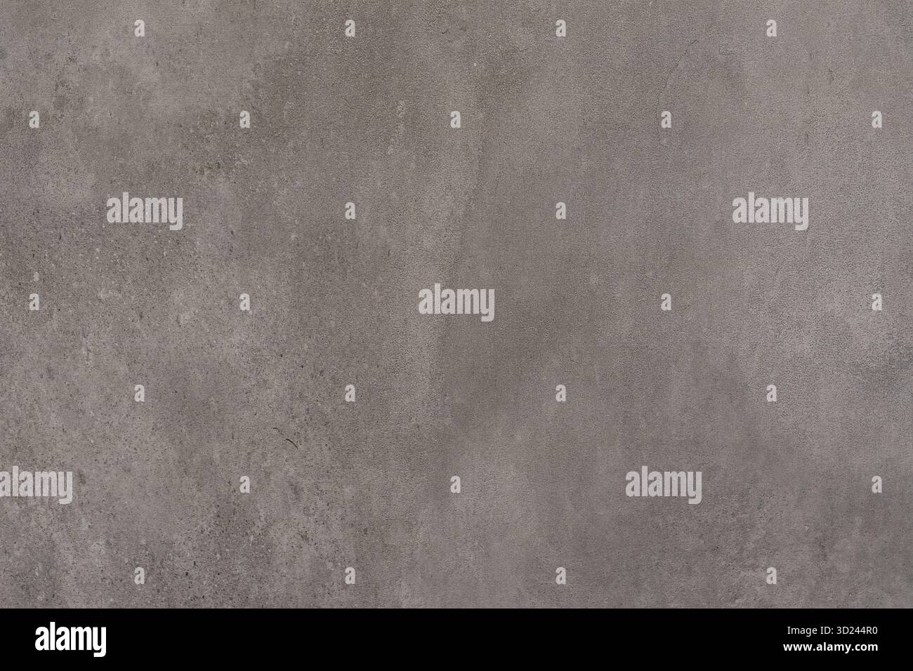 Wandstruktur aus Beton mit subtilen Farbvariationen und einer glatten Oberfläche bei natürlichem Licht Stockfoto