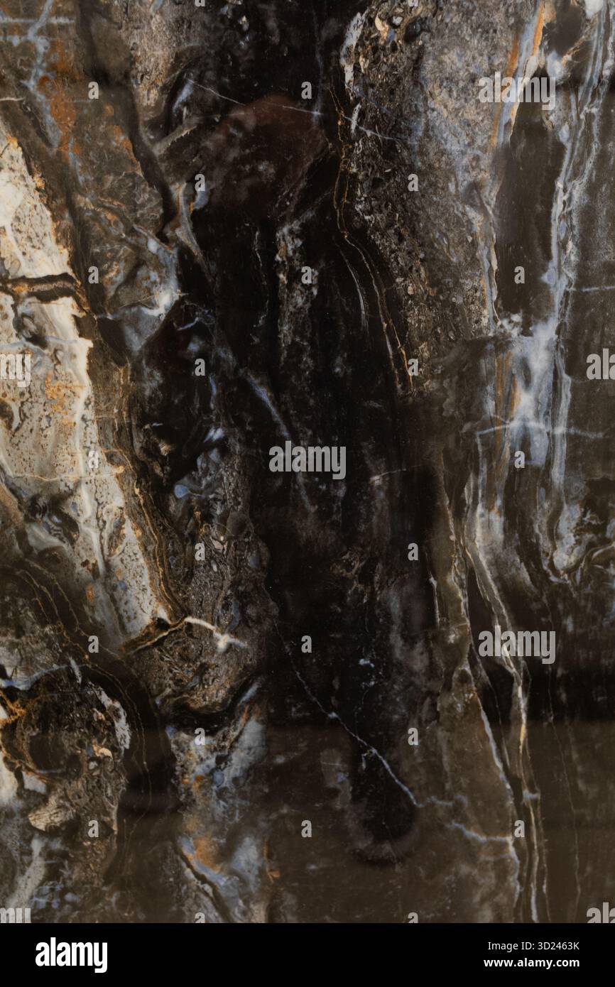Dunkle und reichhaltige Marmorstruktur mit natürlichen Mustern und Farben, die in Steinoberflächen zu finden sind Stockfoto