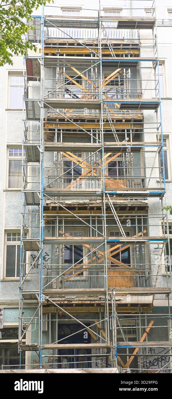 Belin, Deutschland - 19. Mai 2025: Gebäude werden renoviert, wobei Gerüste und Baumaterialien in urbaner Umgebung sichtbar sind. - Smartphone-aufgenommenes Stockfoto