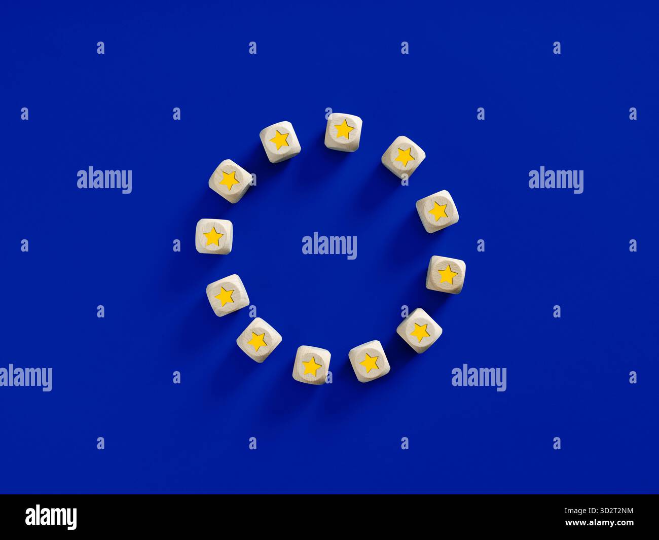 Zwölf Holzwürfel mit gelben Sternen bilden einen Kreis auf blauem Hintergrund, der die Flagge der Europäischen Union symbolisiert Stockfoto