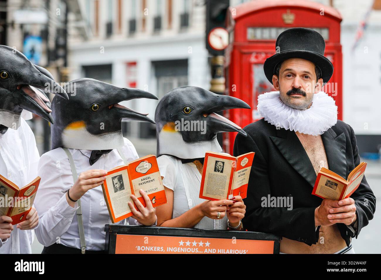 London, Großbritannien. November 2025. Garry und die Pinguine genießen ihre Pinguin Classics außerhalb des Theaters. Der Penguin-Enthusiast und Komiker Garry Starr (Schauspieler und Schriftsteller Damien Warren-Smith) veranstaltet seinen Penguin Book Club, der 9 niedliche, überlebensgroße Pinguine in Soho zusammenbringt, um Penguin Classics vor dem Aussterben zu retten. Quelle: Imageplotter/Alamy Live News Stockfoto
