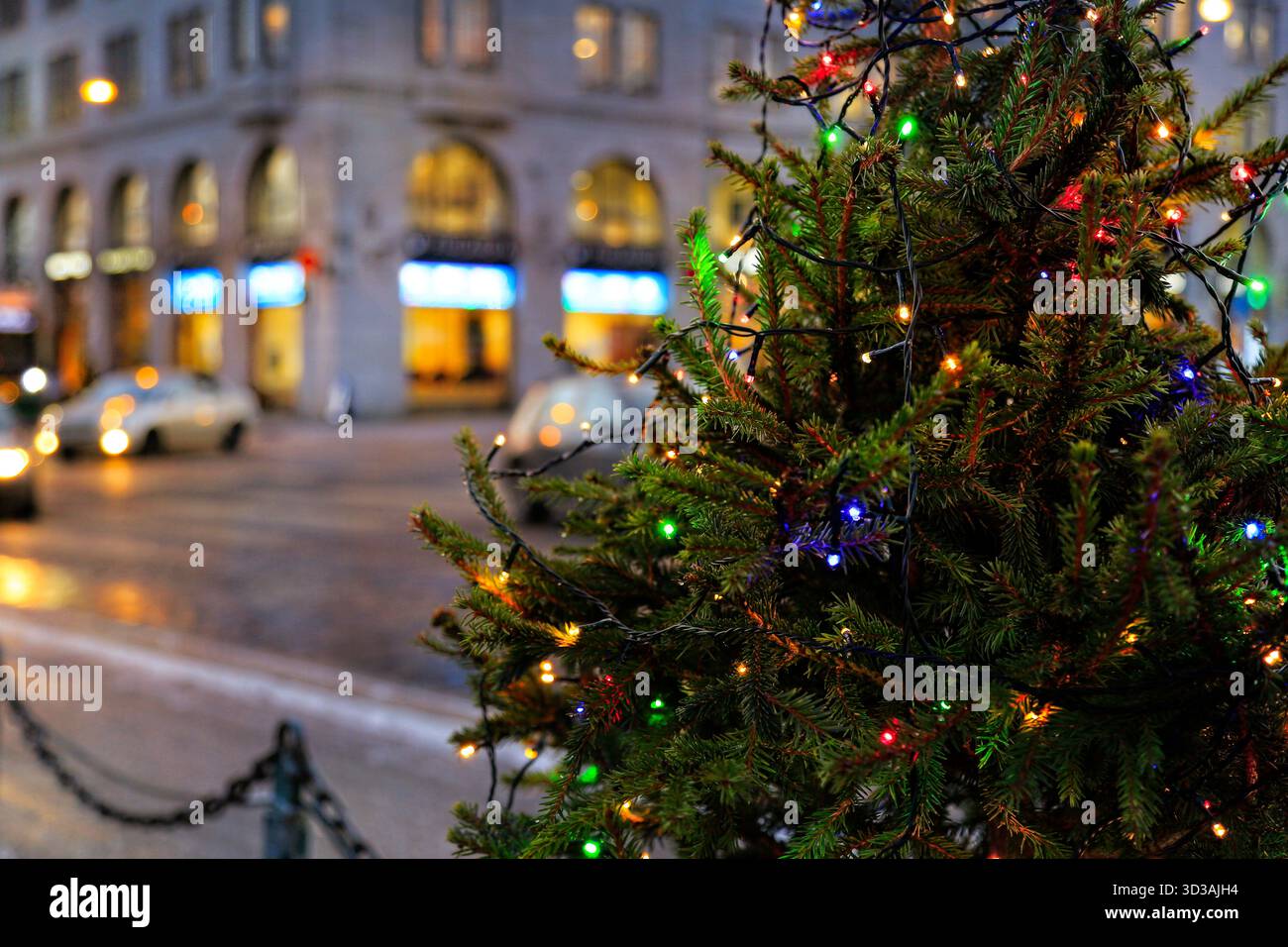 Kleiner Weihnachtsbaum mit bunten Lichtern, fotografiert im Zentrum von Helsinki im Dezember. Stockfoto