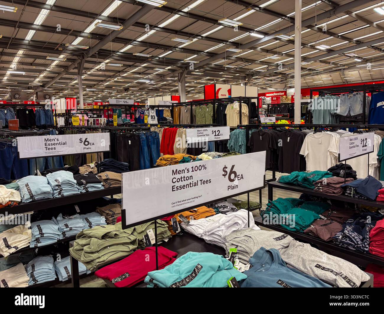 The Warehouse in Neuseeland mit einer großen Auswahl an Herrenbekleidung, einschließlich unverzichtbarer T-Shirts zum Preis von 6 und 12 US-Dollar, was den preisgünstigen Einzelhandel widerspiegelt. Stockfoto