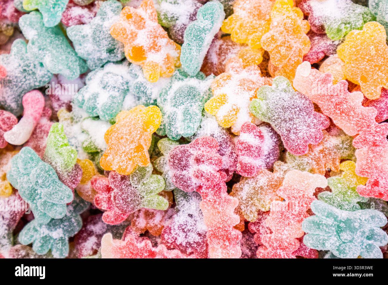 Eine reizvolle Auswahl an bunten Gummibären, die mit Zucker überzogen sind und eine Vielzahl von lebhaften Fruchtaromen bieten. Perfekt für Süßwarenliebhaber, die ein süßes, Stockfoto