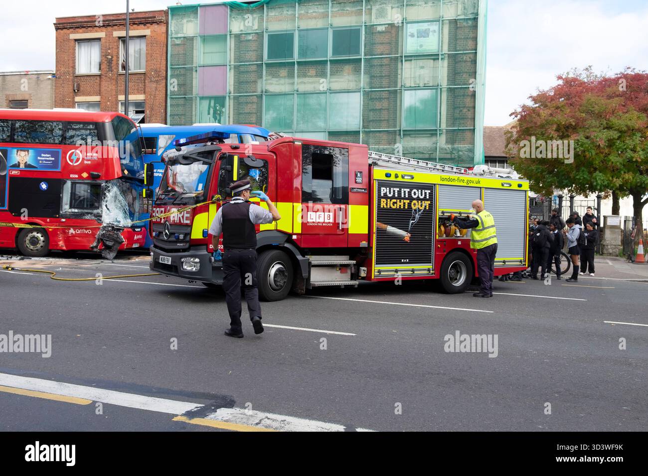 Polizist und Feuerwehrauto bei einem Doppeldeckerverkehrsunfall in Tottenham North London N15 England Großbritannien KATHY DEWITT Stockfoto