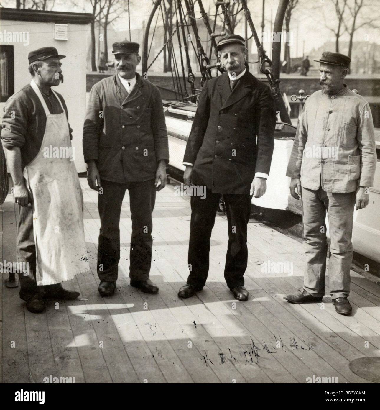 Die Besatzung des Ausbildungsschiffs „Pollux“ in Amsterdam, Niederlande, wird 1918 eingeführt. Bild von links nach rechts: Koch, Hauptbootführer, Kommandant und erster Bootsmann. Stockfoto