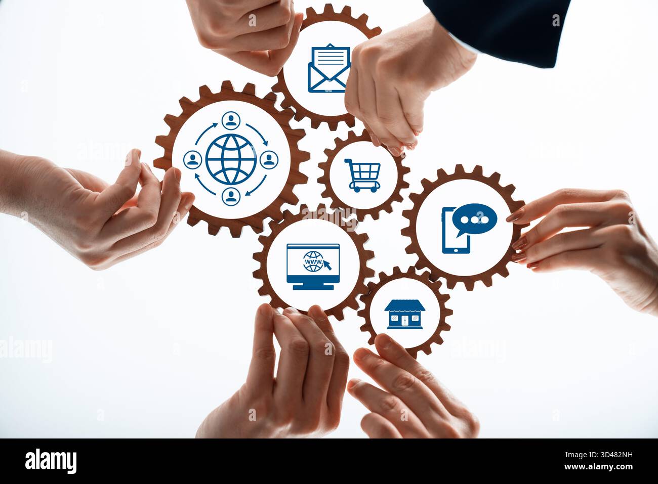 Kollaborative Teamarbeit mit Gears und digitalen Symbolen für Konzepte der globalen Kommunikation, des E-Commerce und der Technologieintegration. Amity Stockfoto