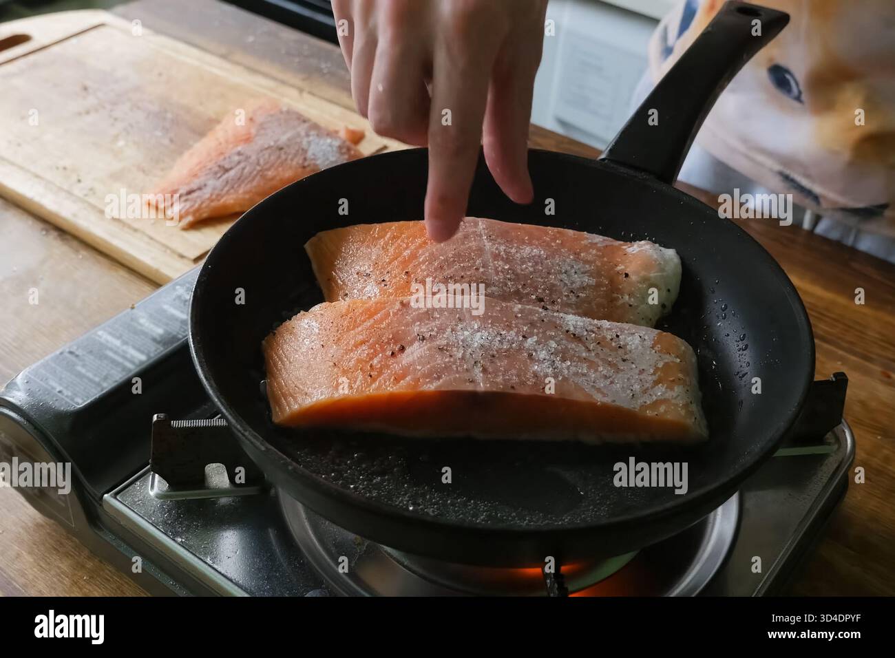 Braten Sie roten Fisch in einer Pfanne. Stücke von roten Fischen. Stockfoto