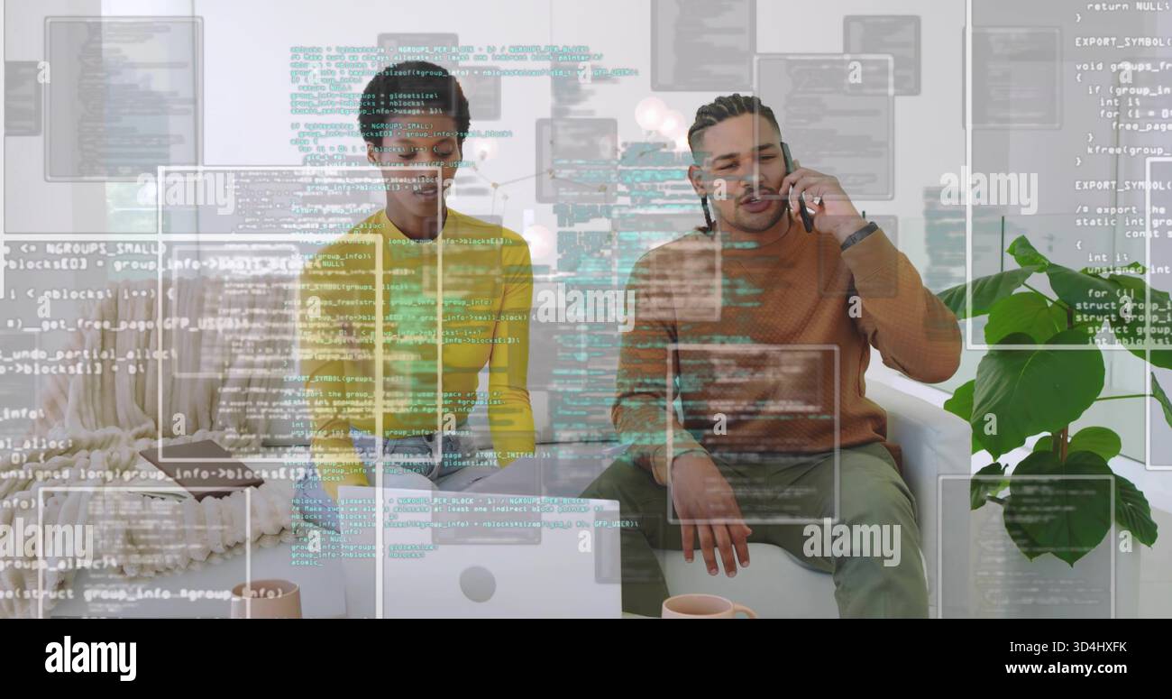 Arbeitendes Duo in gelben und braunen Pullis, die zu Hause auf einem Laptop codieren, Telefon halten, Code-Overlay Stockfoto