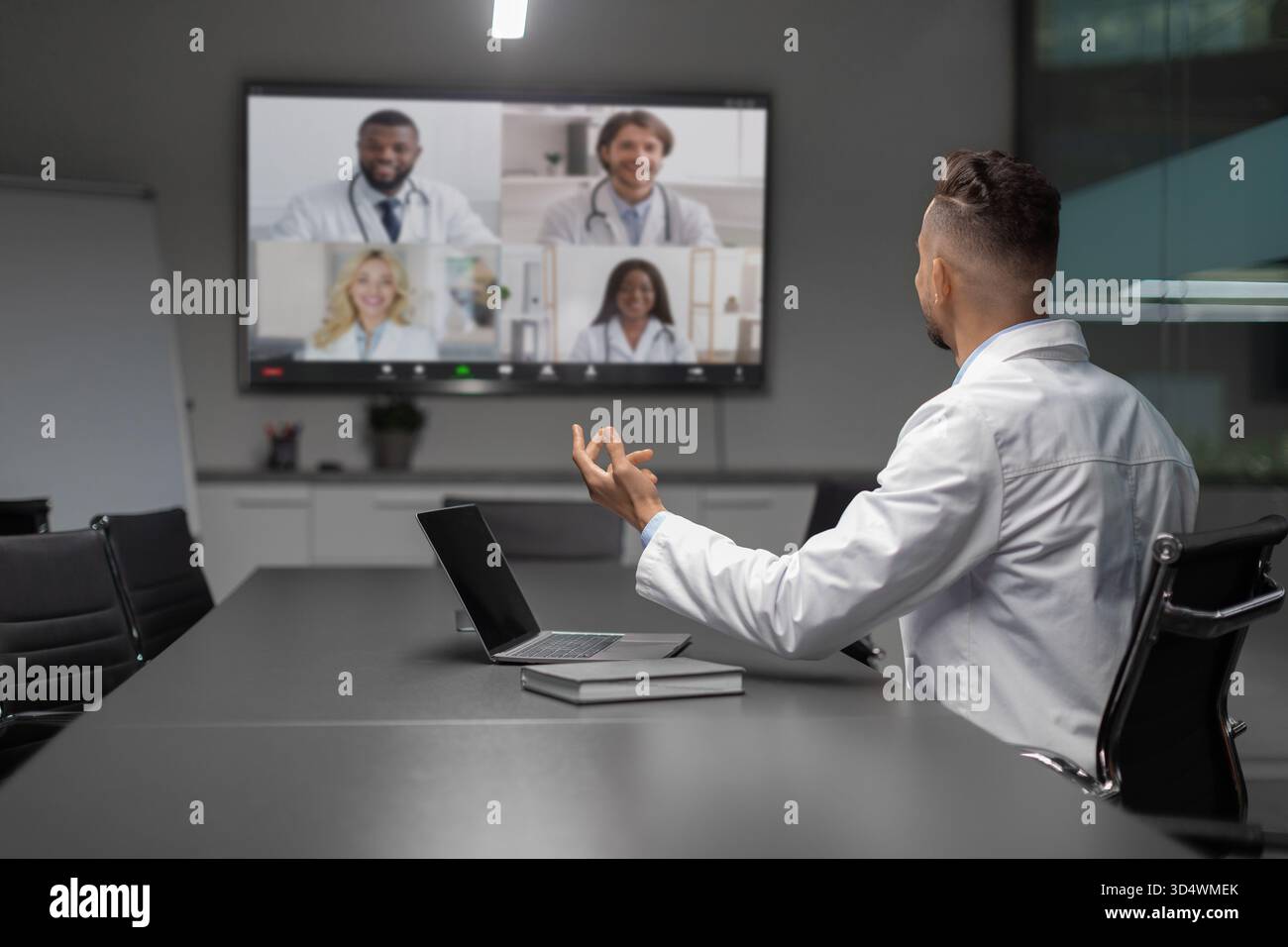 Wissenschaftler aus dem Nahen Osten moderieren Video-Chat mit globalen Kollegen für wissenschaftliche Zusammenarbeit Stockfoto