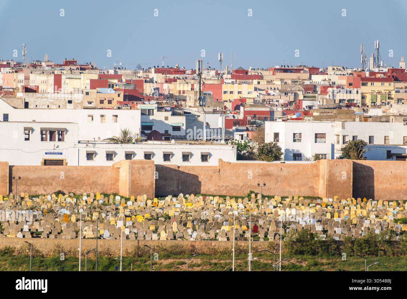 Rabat, Marokko – Eine ruhige, enge Gasse in der historischen Medina von Rabat, gesäumt von weiß getünchten Gebäuden, traditionellen Holztüren und dekorativen Strassen Stockfoto