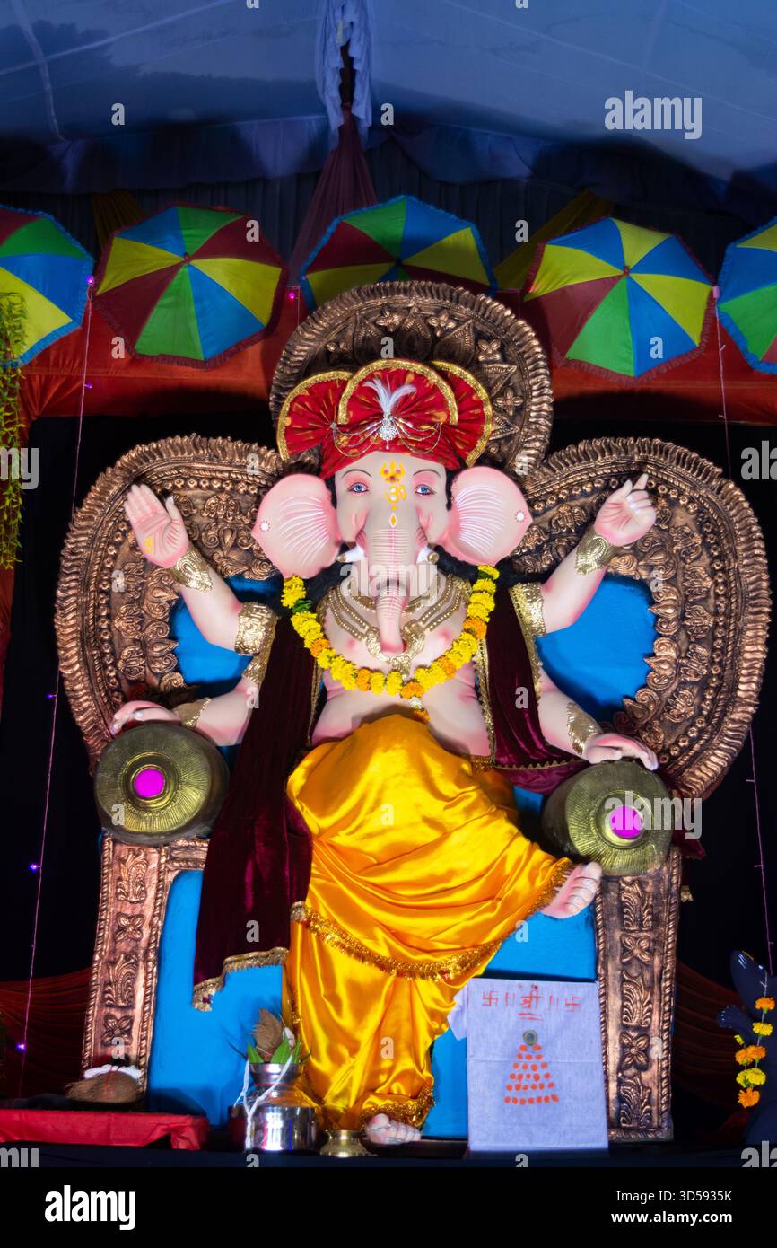 Lord ganesha Idol. Lebendige ganesh Chaturthi-Einrichtung mit bunten Regenschirmen Stockfoto