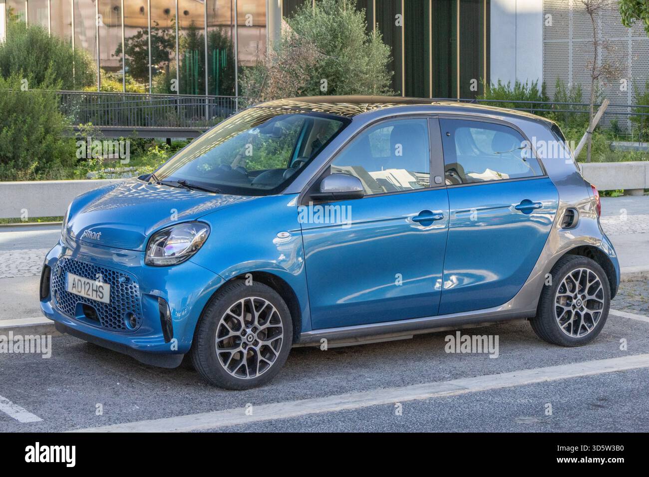 Blaue elektrische Smart-Äq für vier Autos, die auf einer städtischen Straße geparkt sind Stockfoto
