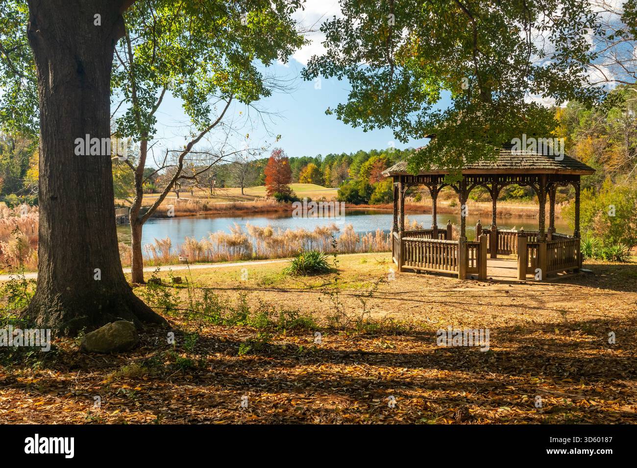 Ein einladender Pavillon überblickt einen Teich an einem hellen sonnigen Tag im Herbst. Stockfoto