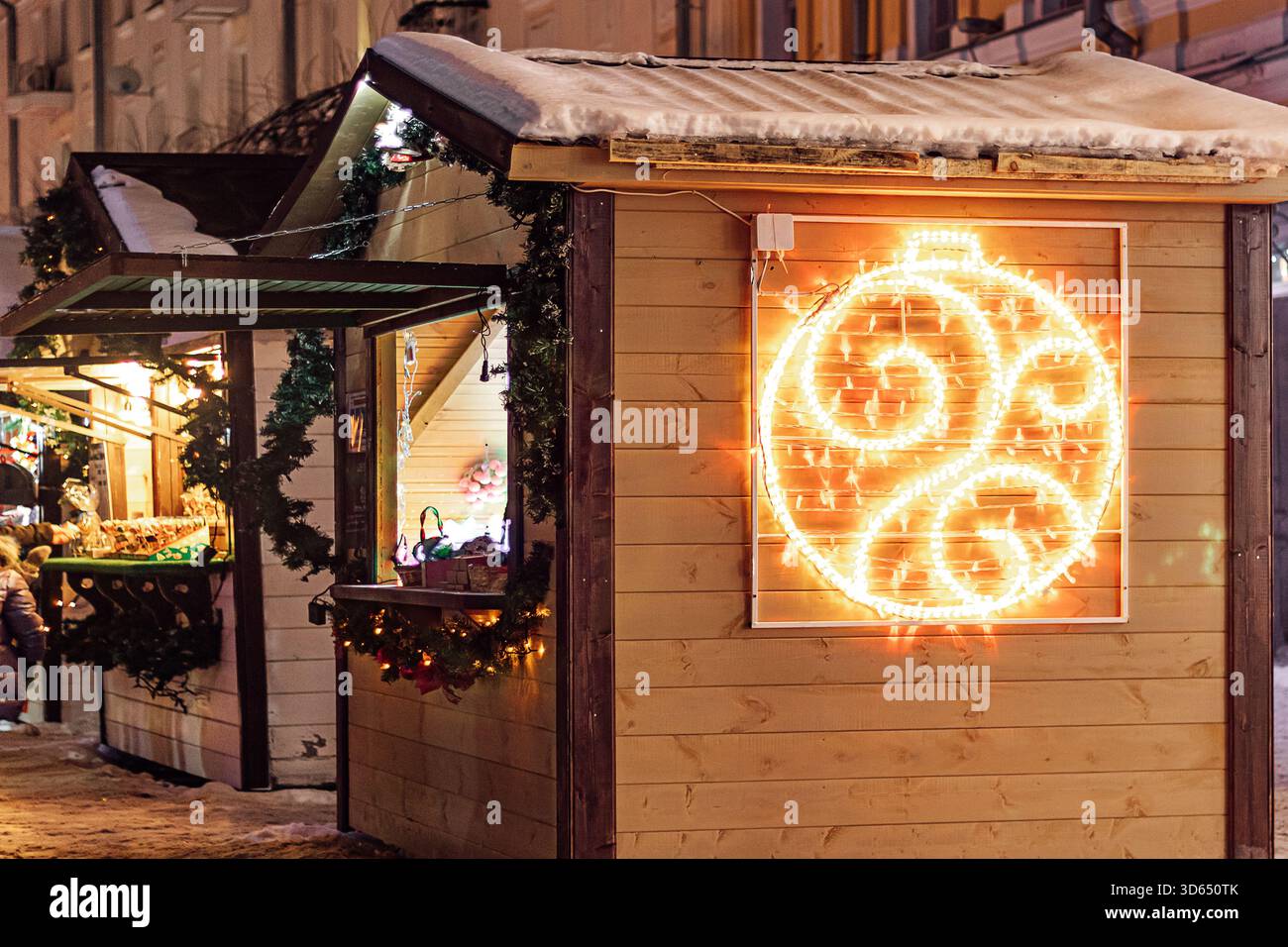 Weihnachtsmarkt. Holzhäuser zum Verkauf von Weihnachtsschmuck und Spielzeug. Winterferien. Stockfoto