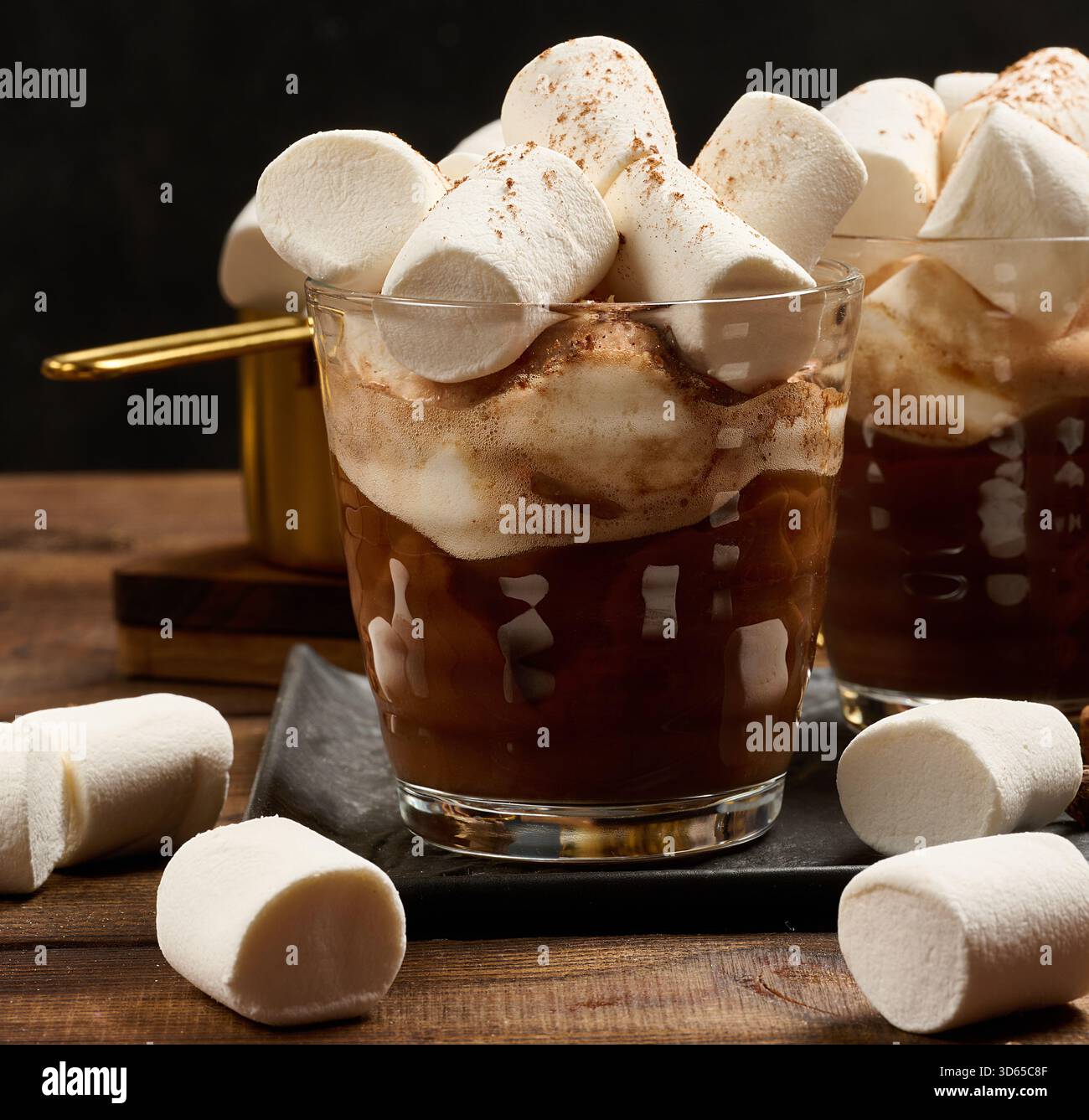 Zwei Gläser heiße Schokolade mit flauschigen Marshmallows auf einem Schieferbrett. Eine Nahaufnahme des Wintergetränks. Stockfoto