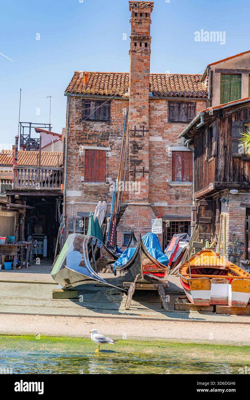 Traditionelle venezianische Gondelwerkstatt, in der Handwerker Gondeln bauen und reparieren und historische Holzstrukturen und authentische Details von Venedig zeigen Stockfoto