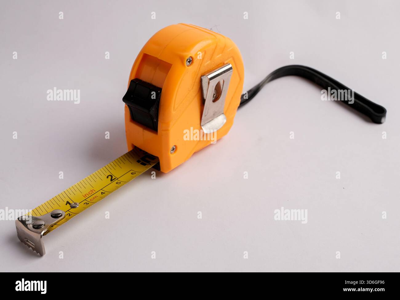 Gelbes Maßband mit schwarzem Band auf weißem Hintergrund. Stockfoto